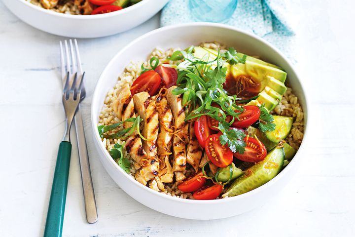 bowl of chicken and rice with cutlery